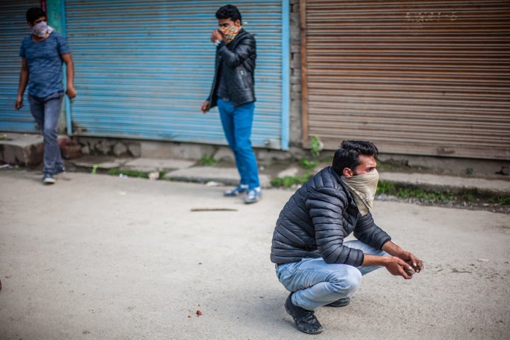 SRINAGAR, KASHMIR, INDIA - MAY 04: Kashmiri student throw stones at Indian government forces, during fresh protest, against the attack by Indian government forces on students, on May 04, 2017, in Srinagar, the summer capital of Indian administered Kashmir, India. Fresh clashes erupted between Kashmiri students and Indian government forces Today in Srinagar. Kashmiri students have been protesting and clashing with Indian forces continuously after an attack by forces on college students in south Kashmir� pulwama district last month. (Photo by Yawar Nazir/Getty Images)