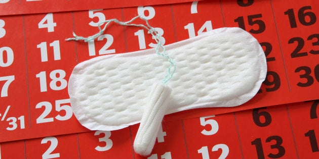 The sanitary napkin lying on a red calendar.