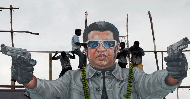 Fans of south Indian film star Rajinikanth pour milk as an offering over his cut-out on the release date of his new movie "Endhiran" (Robot) in the southern Indian city of Chennai October 1, 2010. REUTERS/Babu (INDIA - Tags: ENTERTAINMENT ODDLY)