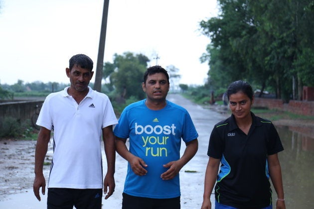 Alakhpura government school's PE teacher Gordhan Dass with the team coach Sonika Bijaria and her husband, who is a boxer.