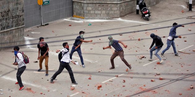 Demonstrators throw stones towards the Indian police during a protest in Srinagar, May 9, 2017. REUTERS/Danish Ismail