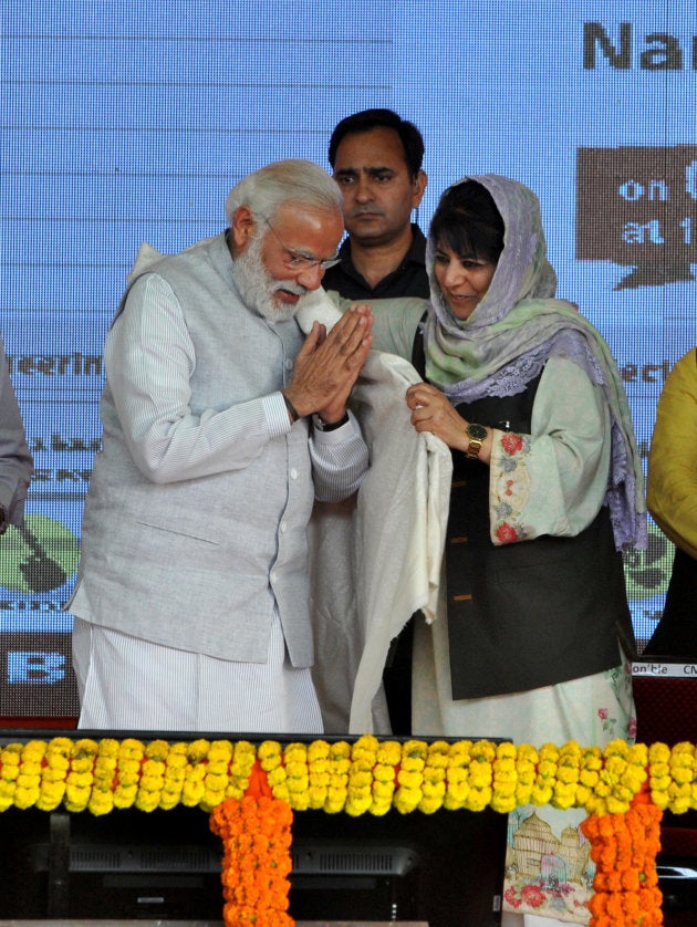 JAMMU, INDIA - APRIL 2, 2017 : Chief Minister Mehbooba Mufti presenting a shawl to Prime Minister Narendra Modi during a public rally.