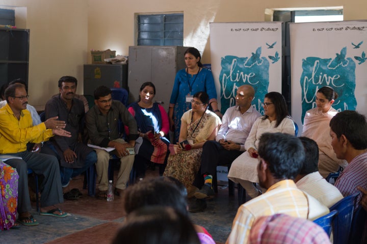 Deepika Padukone (seated, eighth from left) with the TLLLF and APD teams during an interaction with residents of a village in rural Karnataka