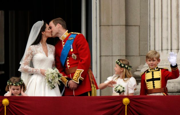 The Duke and Duchess of Cambridge kissing on the balcony at Buckingham Palace.
