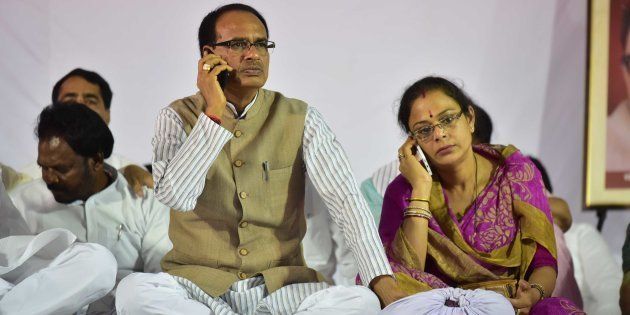Madhya Pradesh Chief Minister Shivraj Singh Chouhan and his wife Sadhna Singh busy with their cell phones during indefinite fast, on June 11, 2017 in Bhopal.