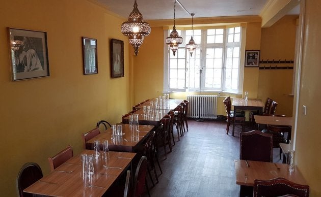 Gandhi smiles down at you as you relish the mediocre fare