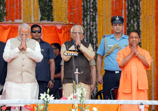 Prime Minister Narendra Modi (L), Uttar Pradesh governor Ram Naik (C) and India?s ruling Bharatiya Janata Party (BJP) leader Yogi Adityanath (R) greet a gathering before Adityanath takes an oath as the new Chief Minister of India?s most populous state of Uttar Pradesh during a swearing-in ceremony in Lucknow, India, March 19, 2017. REUTERS/Pawan Kumar