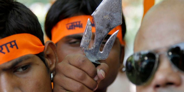 Members from the hardline Hindu groups, Bajrang Dal and Vishwa Hindu Parishad (VHP), hold a trident during a protest in New Delhi May 9, 2011.