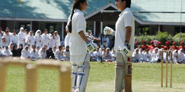 Two Kashmiri batswomen discuss during a cricket match at the Women's College in Srinagar, 13 September 2005.