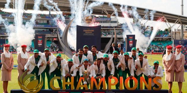 Pakistan players pose with the trophy as they celebrate their win at the presentation after the ICC Champions Trophy final cricket match between India and Pakistan at The Oval in London on June