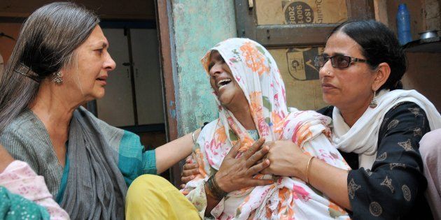 Polit Bureau member Brinda Karat consoling Zaira (C), mother of Junaid who was lynched by a mob while onboard a train, in Haryana on Saturday.