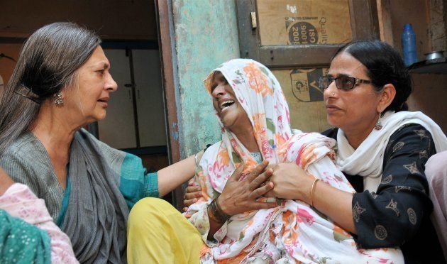 CPI(M) Polit Bureau member Brinda Karat consoling Zaira (C), mother of Junaid who was lynched by a mob while onboard a train, in Haryana on Saturday.