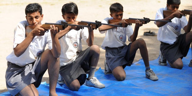 Volunteers of Bajrang Dal participate in the air rifle training session at a youth camp on the outskirts of Ahmedabad in the early morning of May 17, 2012.