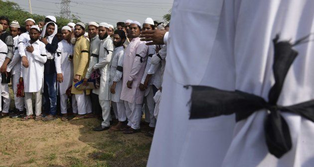 Muslim villagers offer prayers wearing a black band on the occasion of Eid-Ul-Fitr as mark of a silent protest, after the death of 15-year-old Junaid, who was murdered after a scuffle which broke out in a train over a seat in Haryanas Palwal, at Ballabgarh, Faridabad, on June 26, 2017 in New Delhi, India.