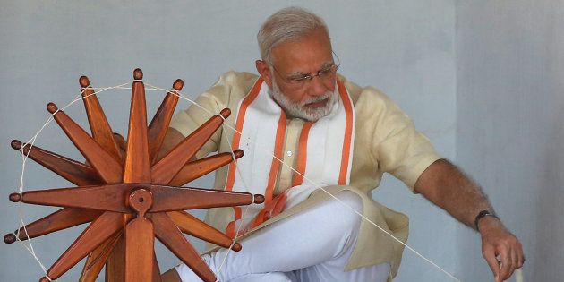 India's Prime Minister Narendra Modi spins cotton on a wheel during his visit to Gandhi Ashram in Ahmedabad, India, June 29, 2017. REUTERS/Amit Dave