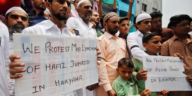 Muslims hold banners as they protest against the recent cases of mob lynching of Muslims who were accused of possessing beef, after offering Eid al-Fitr prayers in Ahmedabad, India June 26, 2017.