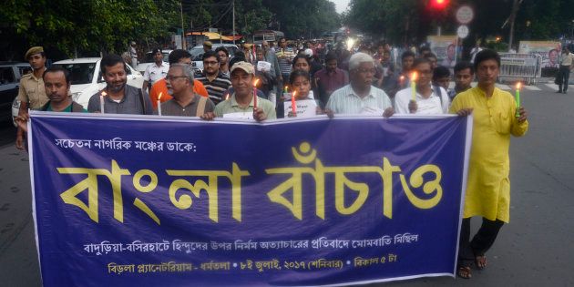 A group of activist participates in a candle light vigil against recent communal violence at Baduria of North 24 Parganas in Kolkata.