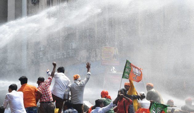 {olice fire a water cannon at activists of the Bhartiya Janata Party (BJP) next to the state police headquarters in Kolkata on May 25, 2017.