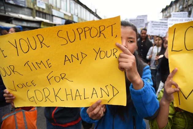 Supporters of the Gorkha Janmukti Morcha (GJM) called indefinite strike from June 15 and chant slogans as they take part in protest on 9 July 2017 in Darjeeling.