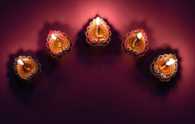 Happy Diwali - Clay Diya lamps lit during Dipavali, Hindu festival of lights celebration
