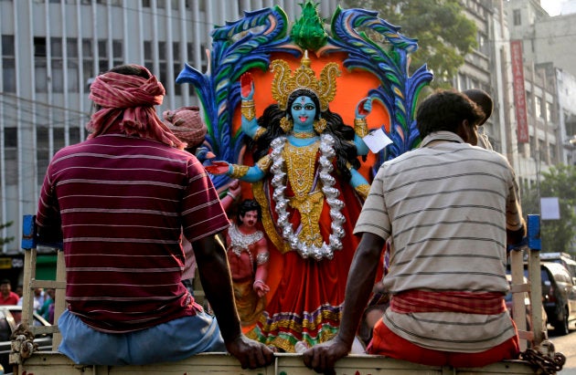 Indian laborers transport an image of Hindu goddess Kali, on a truck ahead of Kali Puja festival in Kolkata, India, Sunday, Nov. 8, 2015. Kali Puja will be celebrated on Nov. 10. (AP Photo/ Bikas Das)