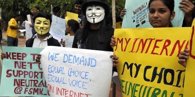 Indian activists wear Guy Fawkes masks as they hold placards during a demonstration supporting 'net neutrality' in Bangalore on April 23, 2015.