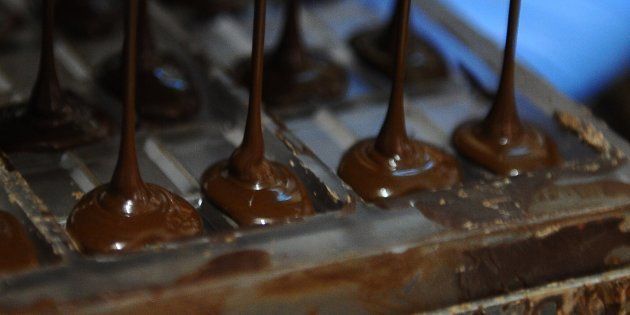 Chocolate melts in a mould at a factory.