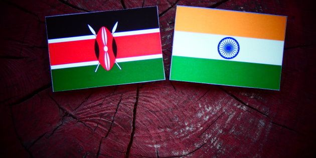 Kenyan flag with Indian flag on a tree stump.