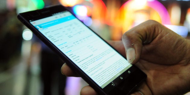 HOWRAH, INDIA - FEBRUARY 26: A passenger using mobile phone/smart phone devices for electronic ticketing system at Howrah Station on February 26, 2015 in Howrah, India. (Photo by Indranil Bhoumik/Mint via Getty Images)