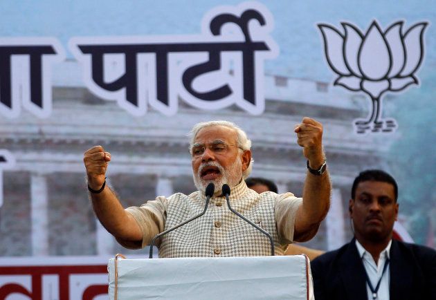 Narendra Modi, then prime ministerial candidate for Bharatiya Janata Party (BJP), gestures as he addresses his supporters during a public meeting in Vadodra in Gujarat May 16, 2014.
