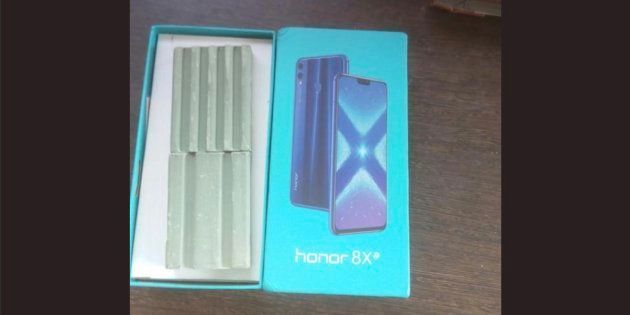 Two bars of soap can be seen in the box for a smartphone.