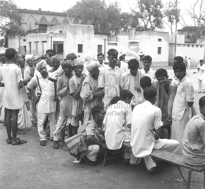 Refugees just arrived from West Punjab line up to get their names registered prior to admission the respective camps. (Photo taken on September 27, 1947).