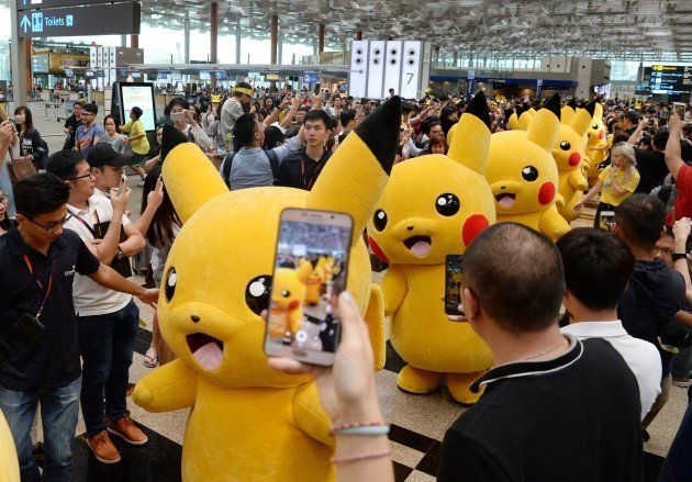 Fans gather to watch a Pikachu parade.