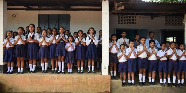 In this photograph taken on June 1, 2016, Indian schoolchildren take part in morning prayers at Rashtriya Swayamsevak Sangh(RSS)run Sankardev Sishu Nikatan School in the Betkuchi area of Guwahati.