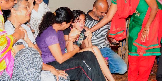 Family members and relatives of 55-year-old Gauri Lankesh, who was shot dead by unknown assailants in the porch of her home in Bangalore mourn her death overnight on September 5, 2017.