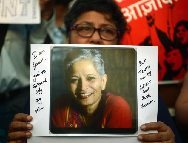 An Indian protester holds a placard in a rally condemning the killing of journalist Gauri Lankesh, in Mumbai on September 6, 2017.