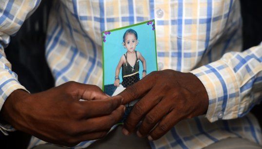 Mohammad Zahid holds his daughter's photograph in Gorakhpur on 14 August, 2017.