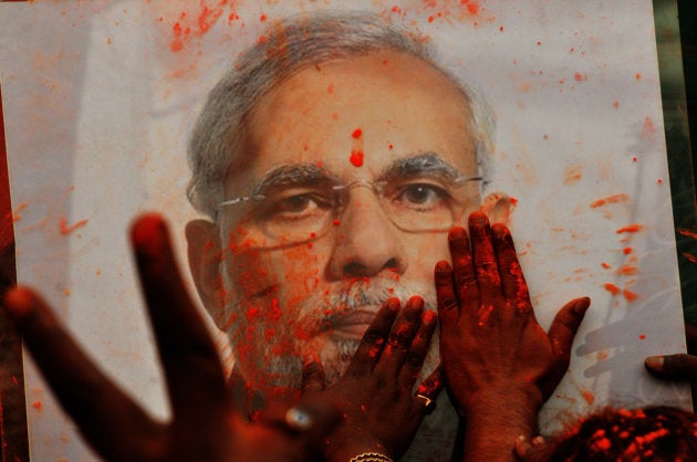 BJP supporters celebrate Holi with Prime Minister Narendra Modi's photograph.