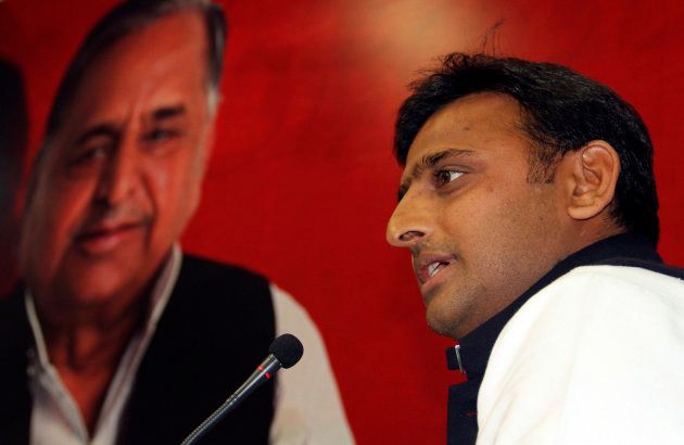 Akhilesh Yadav, the chief minister-designate of the northern Indian state of Uttar Pradesh and state party president speaks in front of a portrait of his father and the Samajwadi Party President Mulayam Singh Yadav, during a meeting with the newly elected legislators at party headquarters in the northern Indian city of Lucknow March 10, 2012.