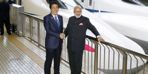 Indian Prime Minister Narendra Modi (R) and Japan's Prime Minister Shinzo Abe pose in front of a Shinkansen bullet train before heading for Hyogo prefecture at Tokyo Station, Japan November 12, 2016, in this photo taken by Kyodo.