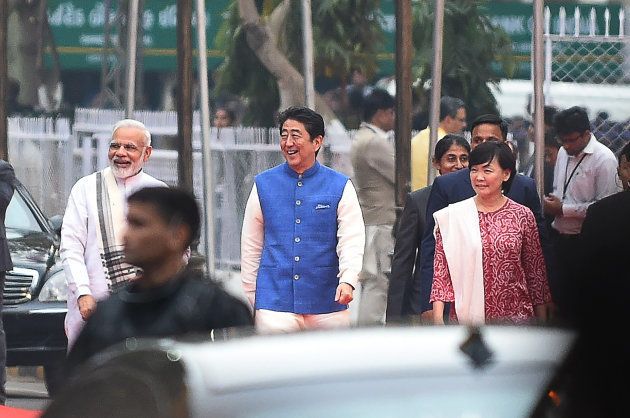 Indian Prime Minister Narendra Modi (L) arrives with Japanese Prime Minister Shinzo Abe (C) and his wife Akie Abe (R) for dinner at a traditional Indian restaurant in Ahmedabad on September 13, 2017.