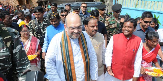 BJP President Amit Shah, along with Chief Minister Raghubar Das and former Chief Minister Arjun Munda, visits the residence of tribal Anil Oraon at Harmu locality.