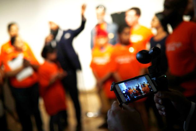 A man livestreams NDP leadership candidate Jagmeet Singh as he speaks at a meet and greet event in Hamilton, Ont. on July 17, 2017.