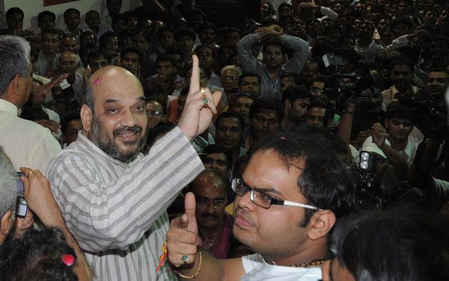 Indian politician and former Gujarat minister Amit Shah (L) and his son Jay celebrate on his arrival at his residence after his release from Sabarmati Central Jail in Ahmedabad late on October 29, 2010.