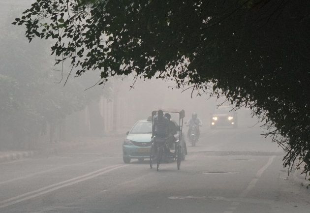Commuters drive amid heavy smog in New Delhi on October 31, 2016, the day after the Diwali.