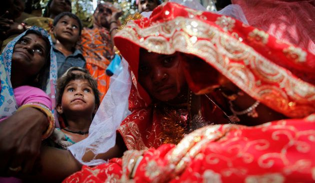 Child bride Krishna,11, sits during a marriage ceremony at her husband's home in a village near Kota in May, 2016.