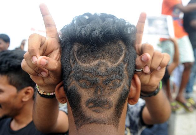 A man with his hair shaved in the shape of a bull poses during a demonstration against the ban on the Jallikattu bull taming ritual in Chennai on January 20, 2017.