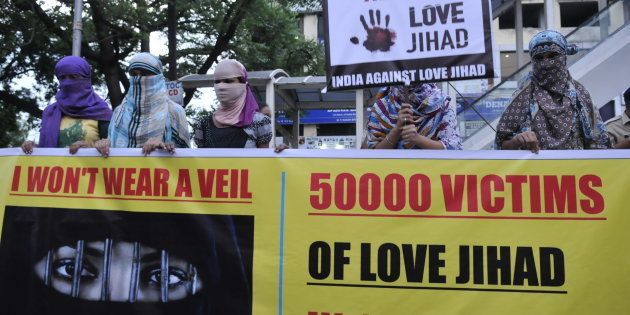 Women associated with India Against Love Jihad hold placards and form a human chain to protest against love jihad and conversion to Islam at MP Nagar on September 12, 2014 in Bhopal, India.
