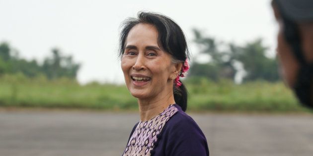 Myanmar State Counselor Aung San Suu Kyi smiles as she walks from a military helicopter after arriving at Sittwe airport on November 2, 2017, following a visit to Maungdaw in Myanmar's Rakhine State.