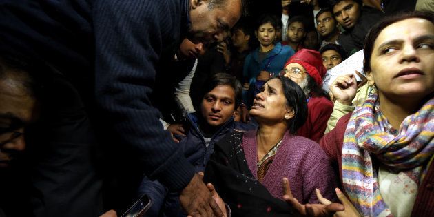 Father of Nirbhaya consoles her mother as she broke down during protest against the release of juvenile convict of the 16 December Gang-rape, along with student activists at Jantar Mantar on December 20, 2015 in New Delhi.